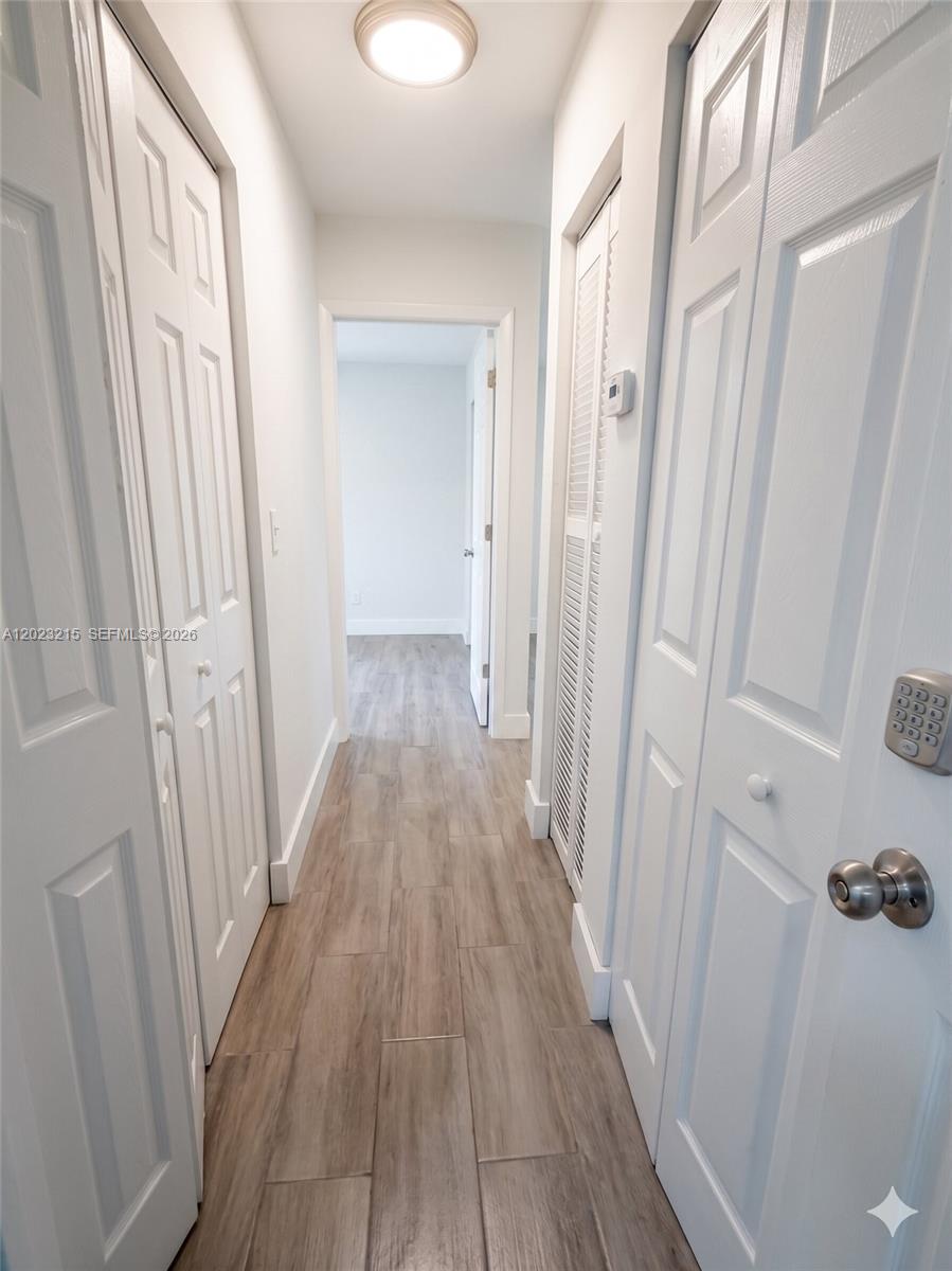 13 Southwest 3rd Street, Unit 13 Pompano Beach, FL 33060 - Photo 18 of 44 a view of a hallway with wooden floor and staircase