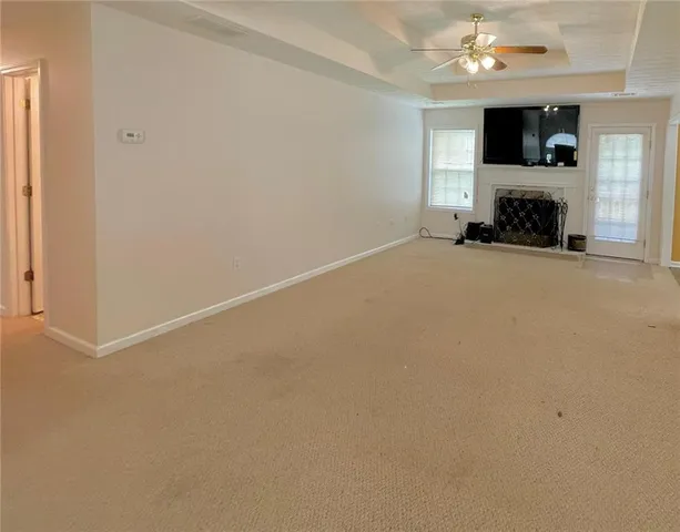 an empty room with a fireplace and a window