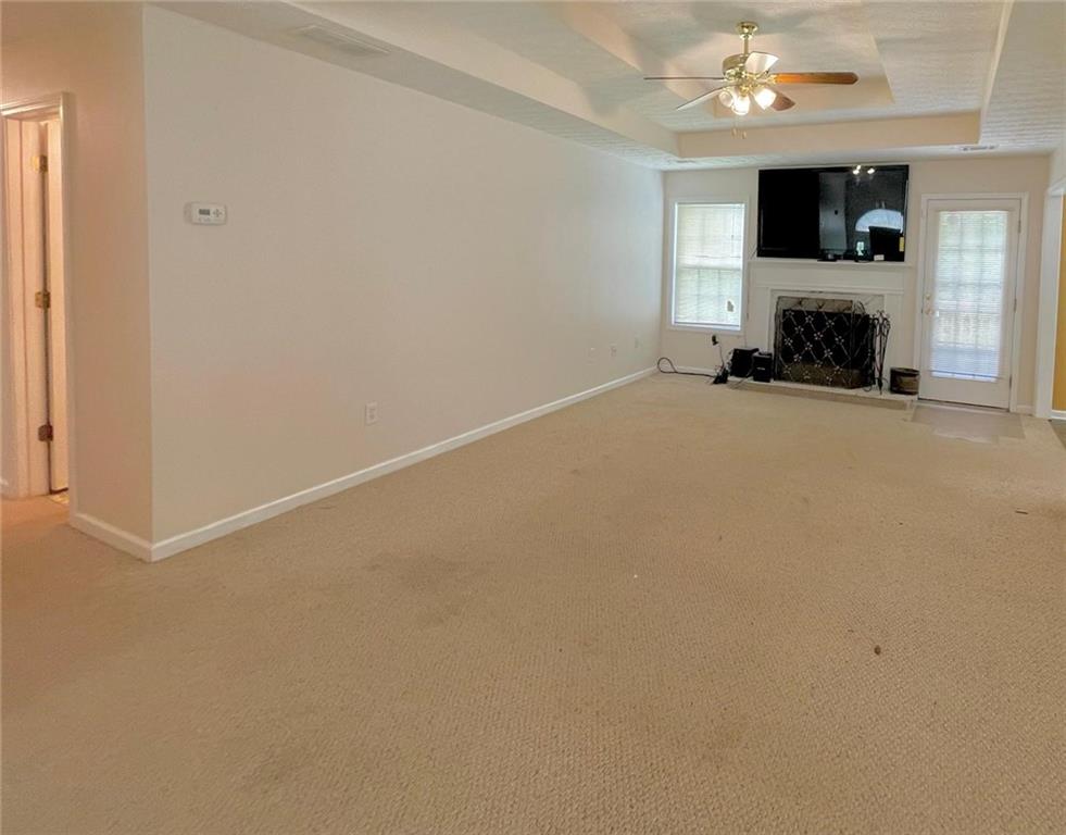 127 Mabry Road Jackson, GA 30233 - Photo 4 of 13 an empty room with a fireplace and a window