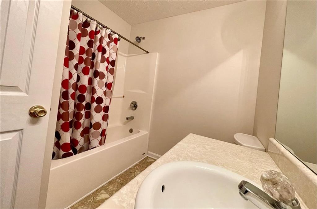 127 Mabry Road Jackson, GA 30233 - Photo 6 of 13 a bathroom with a bathtub and shower