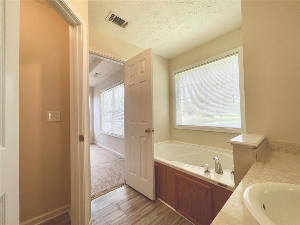 127 Mabry Road Jackson, GA 30233 - Photo 9 of 13 a bathroom with a tub shower and sink