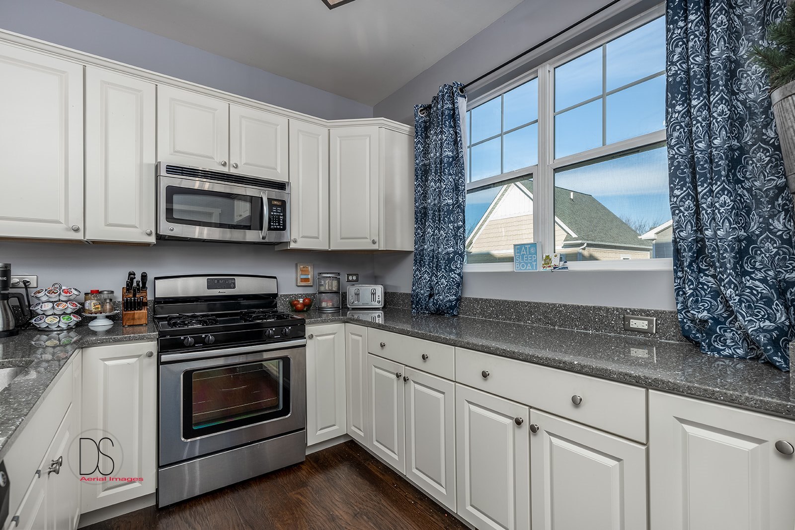 5 River Row Ottawa, IL 61350 - Photo 11 of 31 a kitchen with granite countertop white cabinets and white appliances