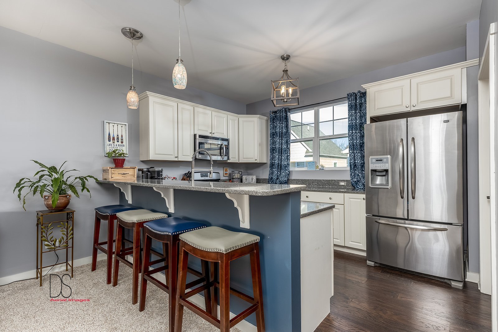 5 River Row Ottawa, IL 61350 - Photo 13 of 31 a kitchen with stainless steel appliances a dining table chairs refrigerator and microwave