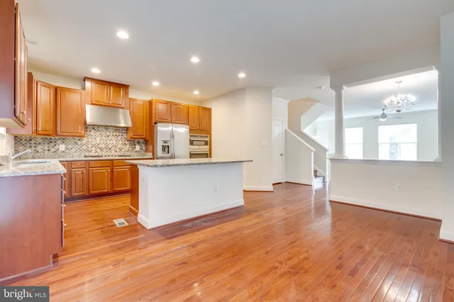 a kitchen with stainless steel appliances granite countertop a sink and a stove