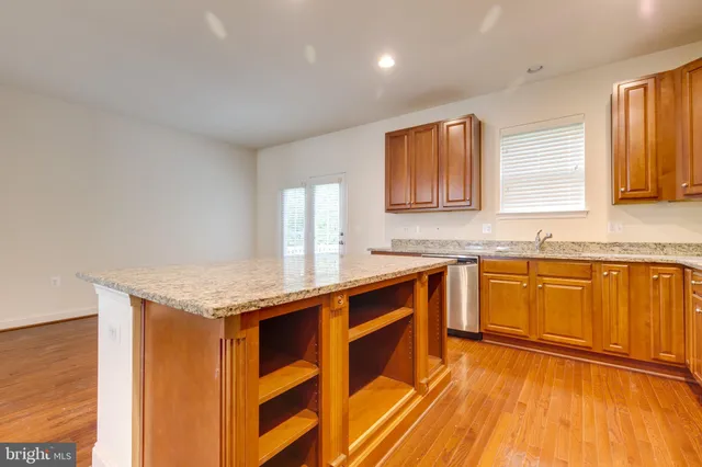 a view of a kitchen with a sink and cabinets