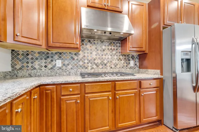 a view of a kitchen with granite countertop cabinets