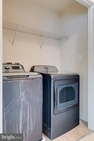 an empty room with windows and fireplace