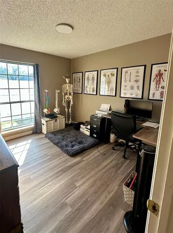 a bedroom with a bed window and a desk