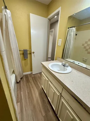 a bathroom with a sink a mirror and a shower