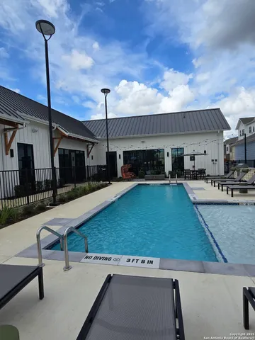 a swimming pool with outdoor seating