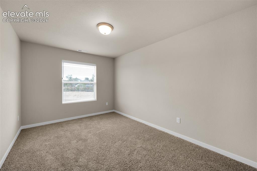6644 Rawhide Rdg View Colorado Springs, CO 80915 - Photo 19 of 26 an empty room with a window