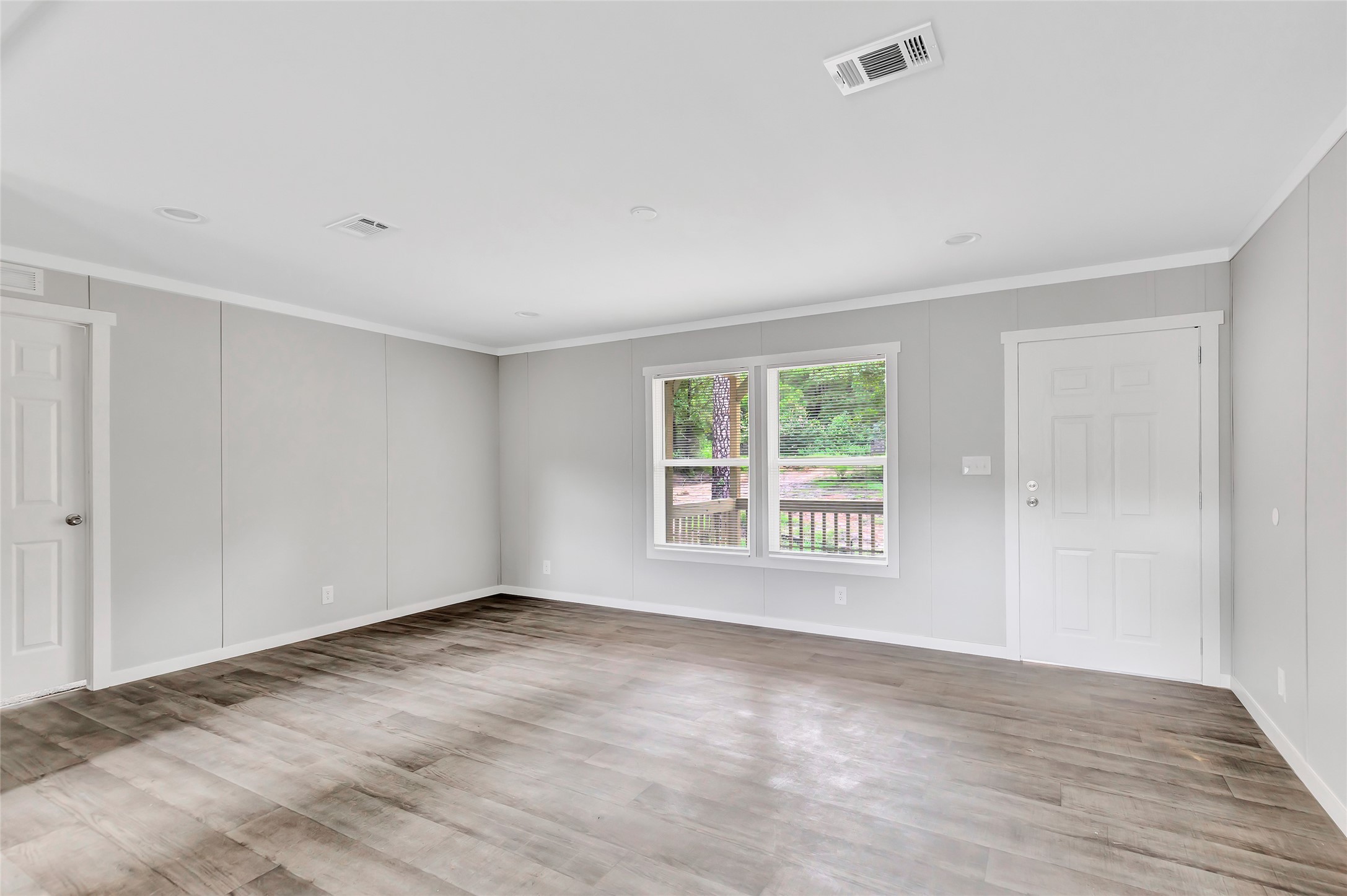 732 Lake Camelot Circle Ivanhoe, TX 75979 - Photo 5 of 18 a view of an empty room with wooden floor and a window