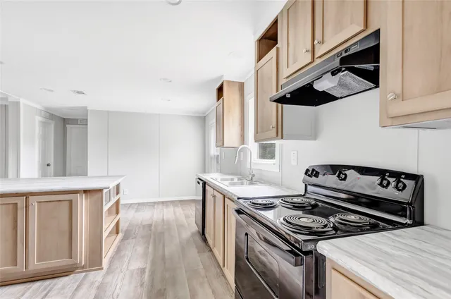 a kitchen with granite countertop a stove and a sink