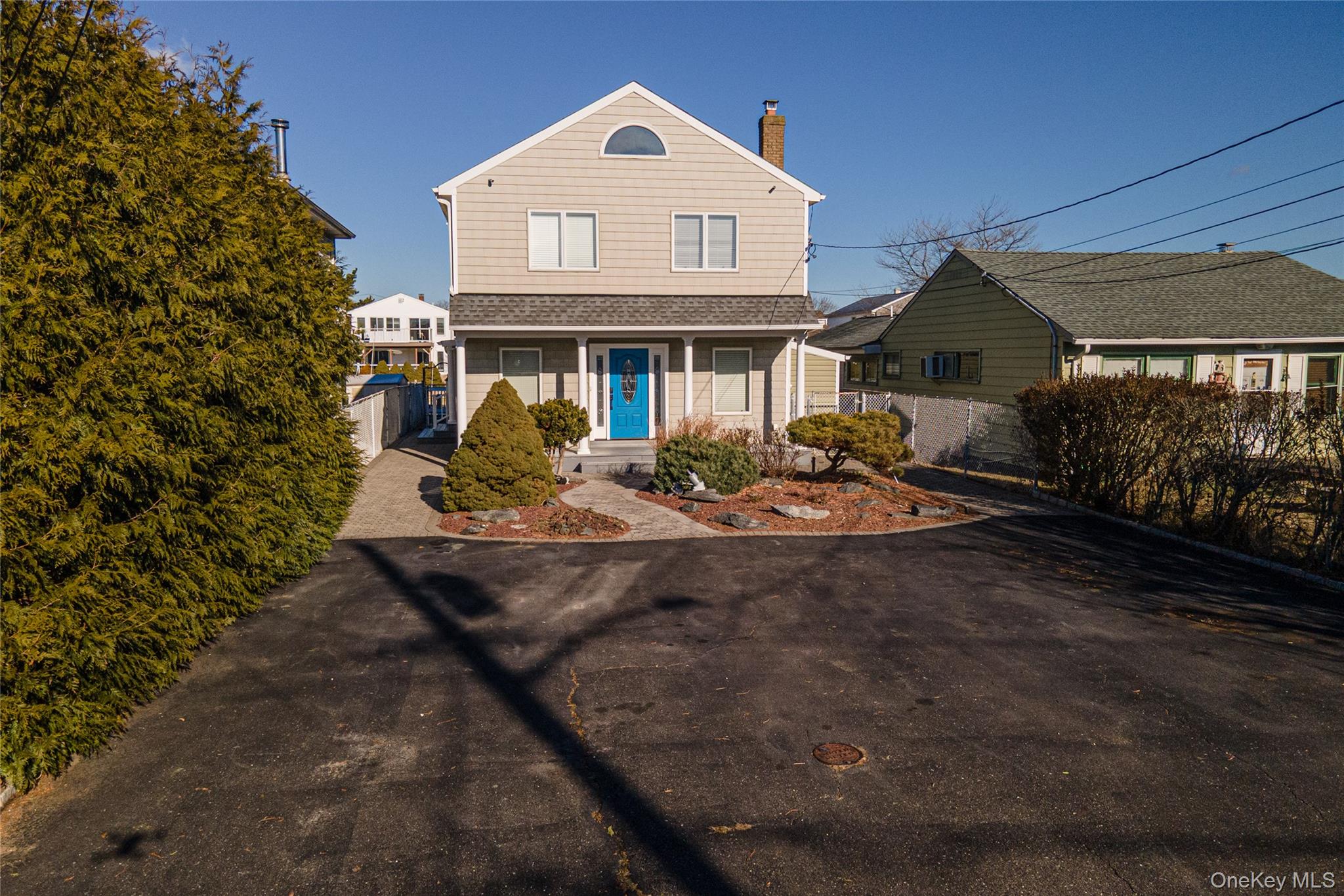 View of front of property with a chimney and covered porch