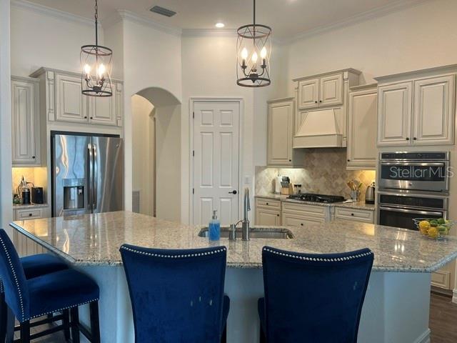 5528 Arnie Loop Lakewood Ranch, FL 34211 - Photo 12 of 59 a kitchen with stainless steel appliances granite countertop a sink stove and refrigerator