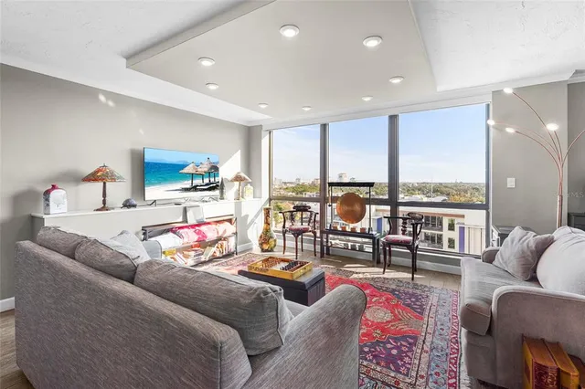 a dining room with furniture a chandelier and wooden floor