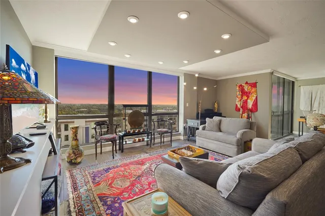 a living room with furniture a rug and a flat screen tv