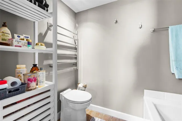 a bathroom with a granite countertop toilet sink and mirror
