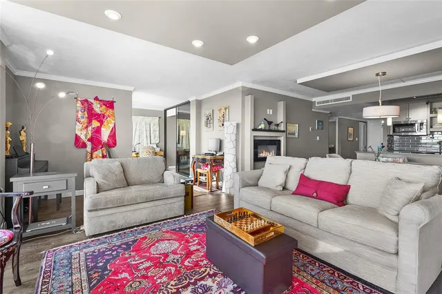 a living room with furniture and a chandelier