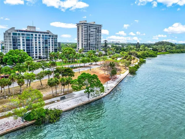 a bathroom with a tub shower and couches