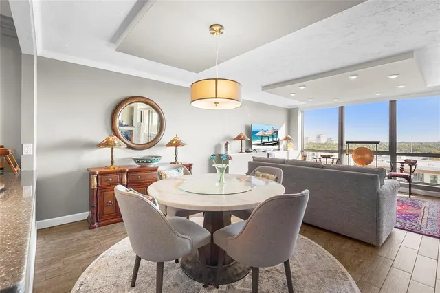 a dining room with furniture a mirror and wooden floor