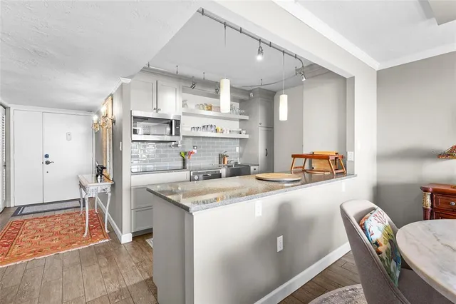 a kitchen with stainless steel appliances a stove a sink and a refrigerator