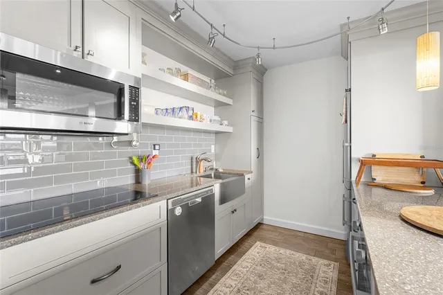 a kitchen with stainless steel appliances a sink a stove and a refrigerator