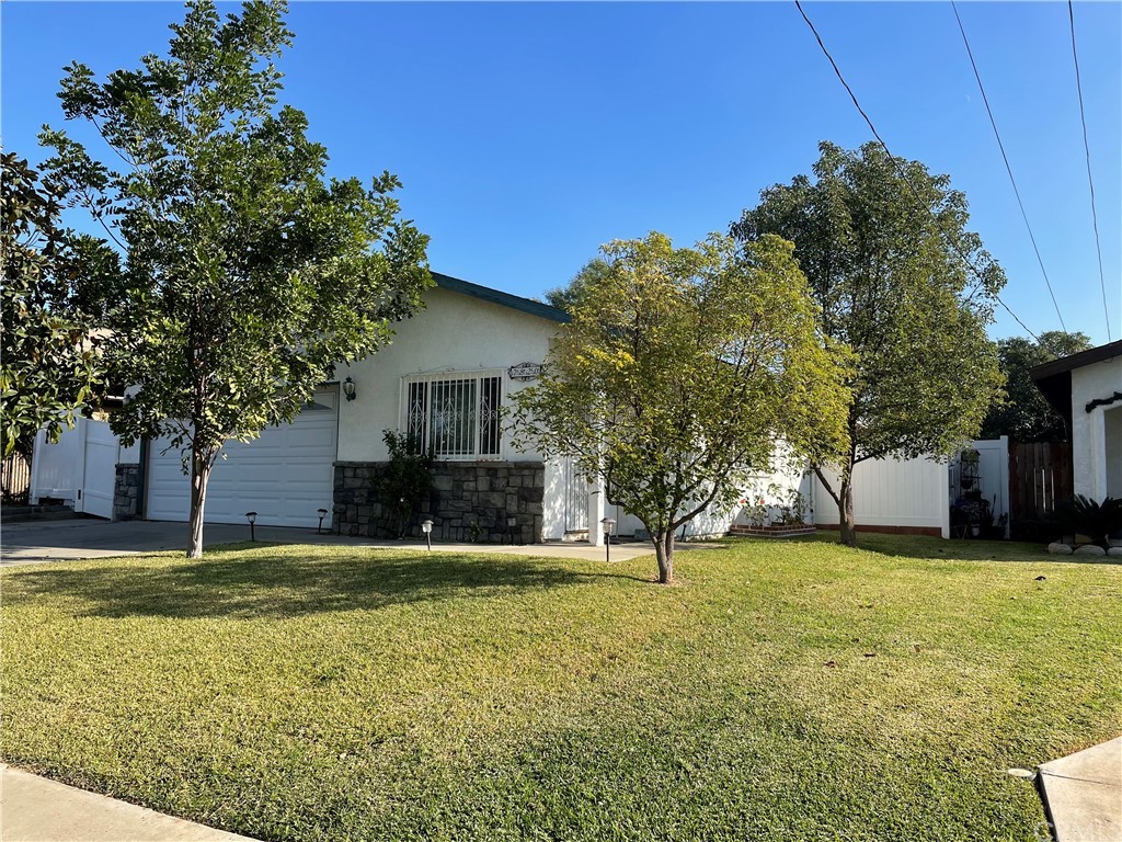 7820 Evans Street Riverside, CA 92504 - Photo 1 of 1 a view of a house with a yard and a tree