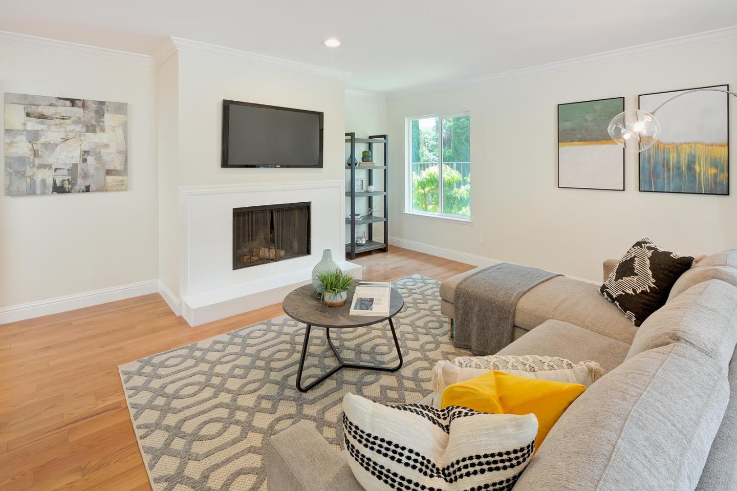 106 Springer Road Los Altos, CA 94024 - Photo 15 of 52 a living room with furniture a flat screen tv and a fireplace