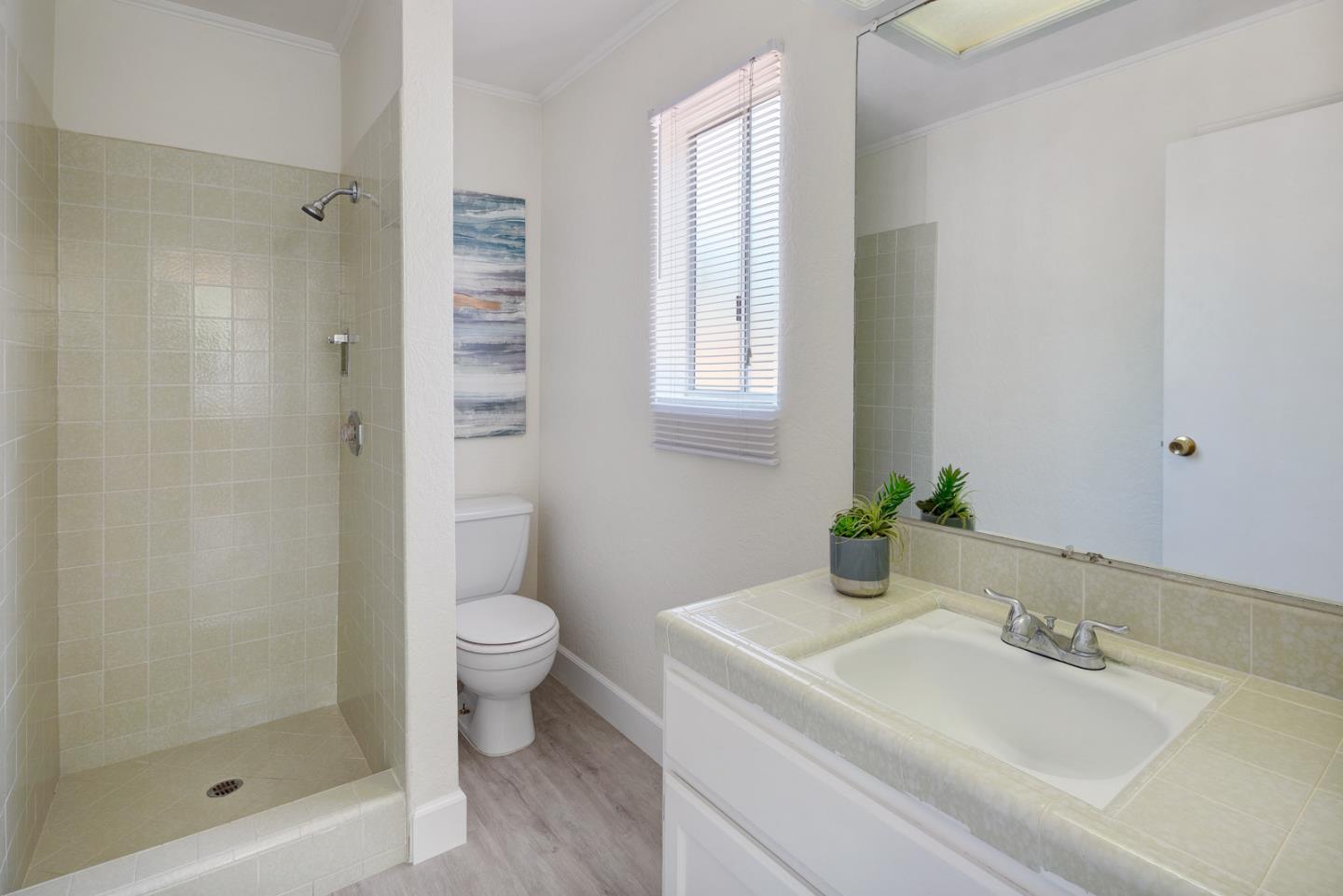 106 Springer Road Los Altos, CA 94024 - Photo 42 of 52 a bathroom with a granite countertop sink toilet and shower