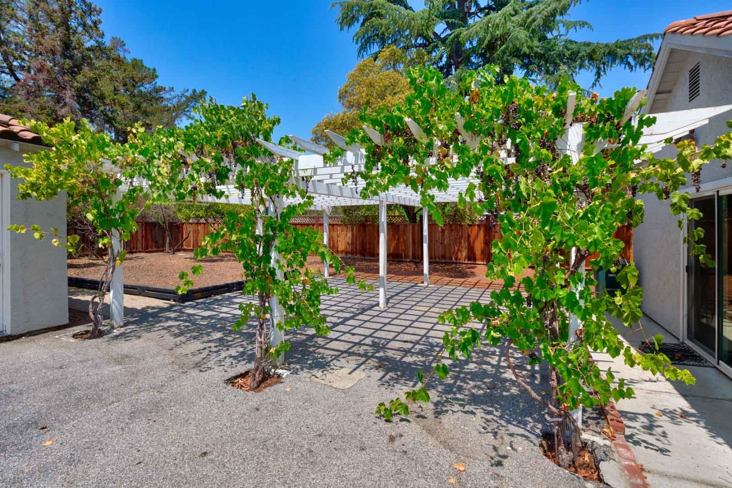 106 Springer Road Los Altos, CA 94024 - Photo 48 of 52 a backyard of a house with barbeque oven and outdoor seating