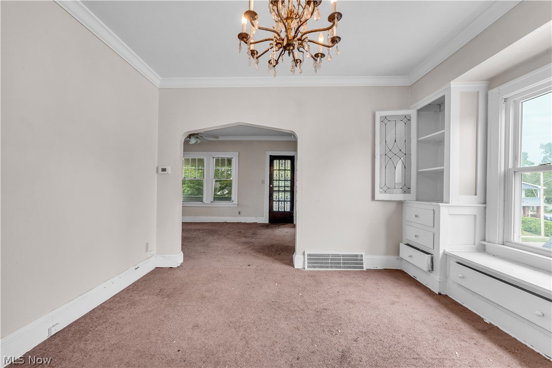 3713 Menlo Road Cleveland, OH 44120 - Photo 16 of 26 Carpeted spare room featuring a notable chandelier and ornamental molding