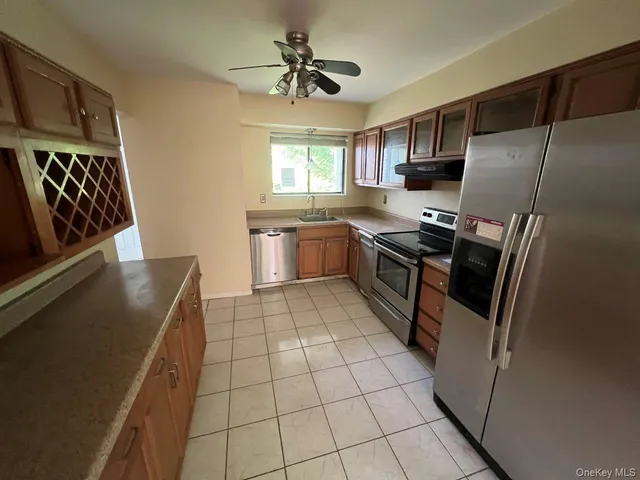 a kitchen with stainless steel appliances a refrigerator sink and stove