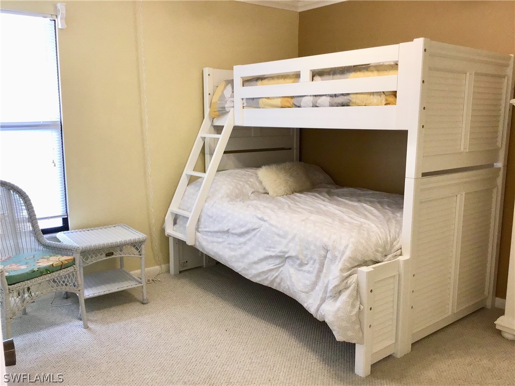 15021 Punta Rassa Road, Unit 704 Fort Myers, FL 33908 - Photo 10 of 18 a bed sitting in a bedroom next to a window
