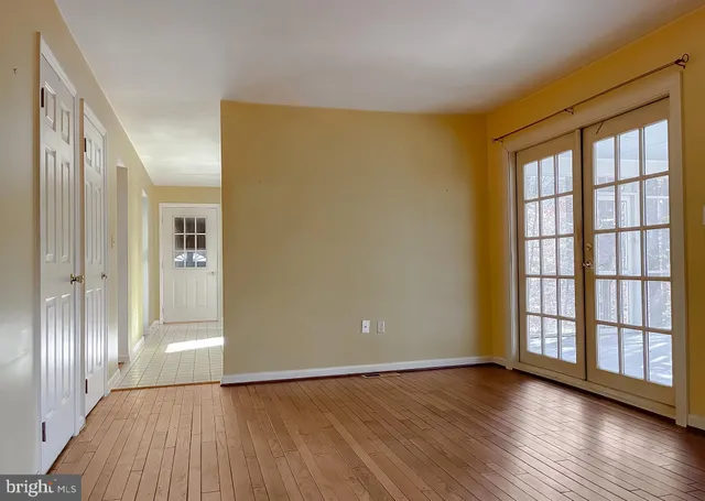 an empty room with windows and bathroom