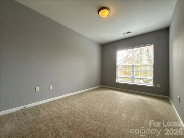 an empty room with a empty space and a window