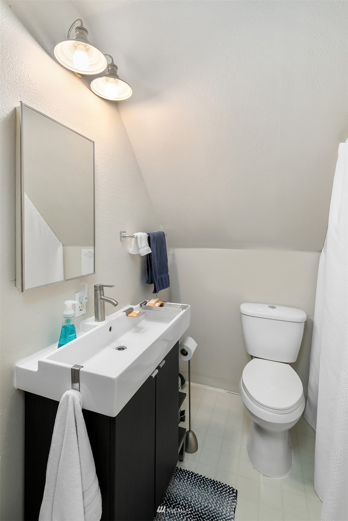 19108 Waxen Road Bothell, WA 98012 - Photo 18 of 31 a bathroom with a toilet sink and mirror