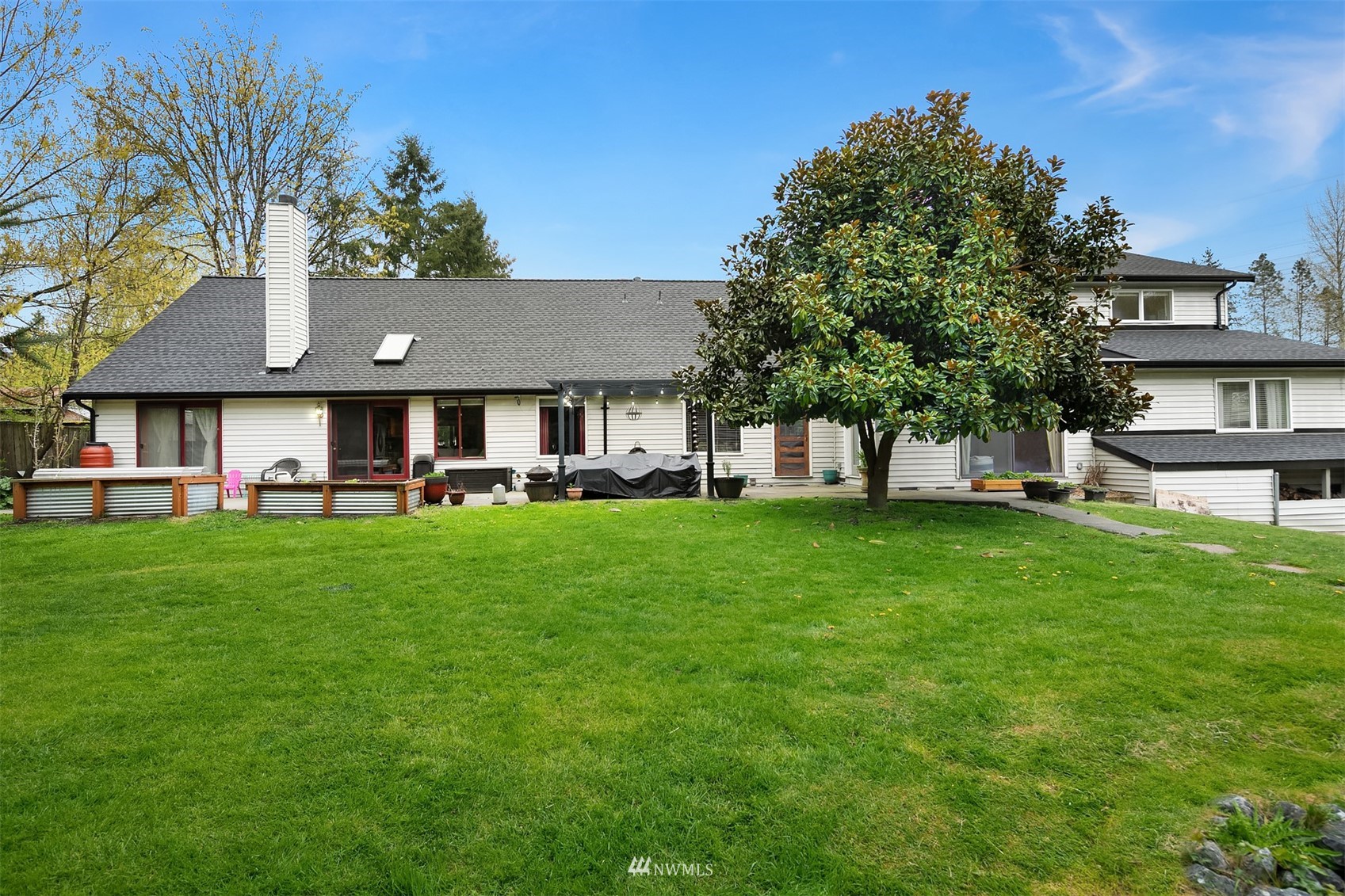 19108 Waxen Road Bothell, WA 98012 - Photo 3 of 31 a front view of a house with a yard table and chairs