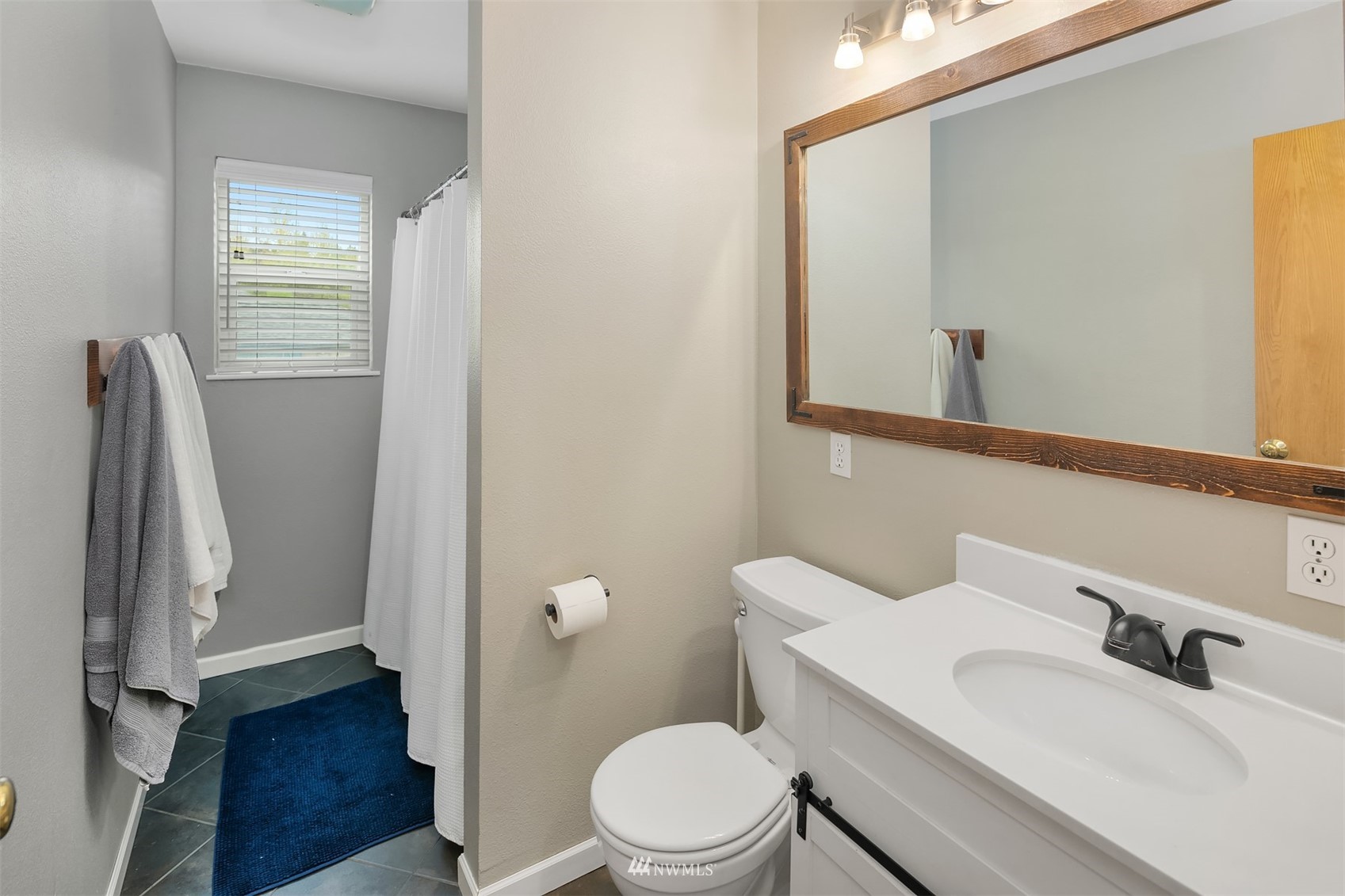 19108 Waxen Road Bothell, WA 98012 - Photo 7 of 31 a bathroom with a sink vanity mirror and toilet