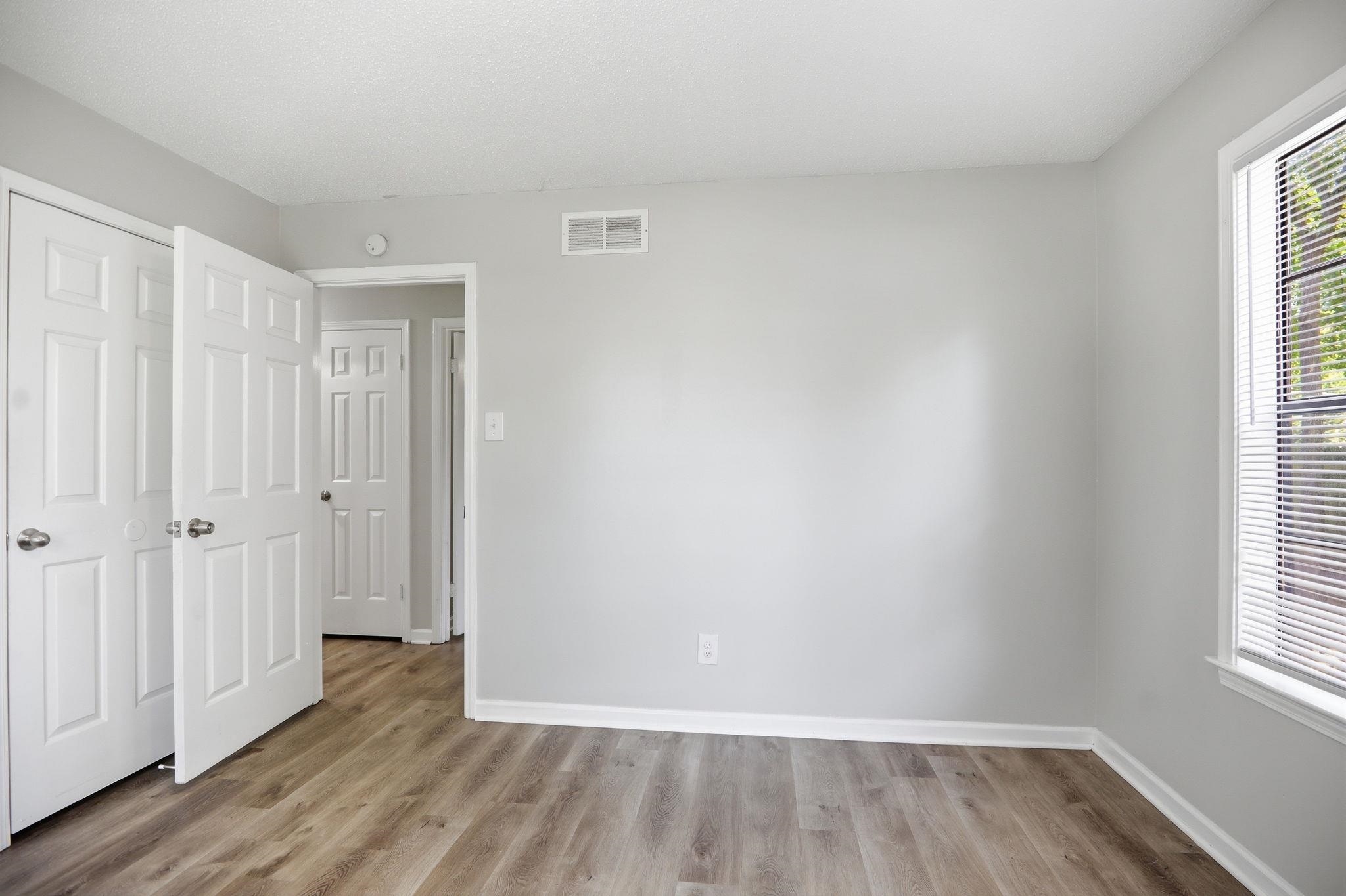 3113 Raleigh Ridge Cove Memphis, TN 38128 - Photo 21 of 38 Room featuring wood-finish flooring, light grey painted walls, white baseboards, and a window with white blinds