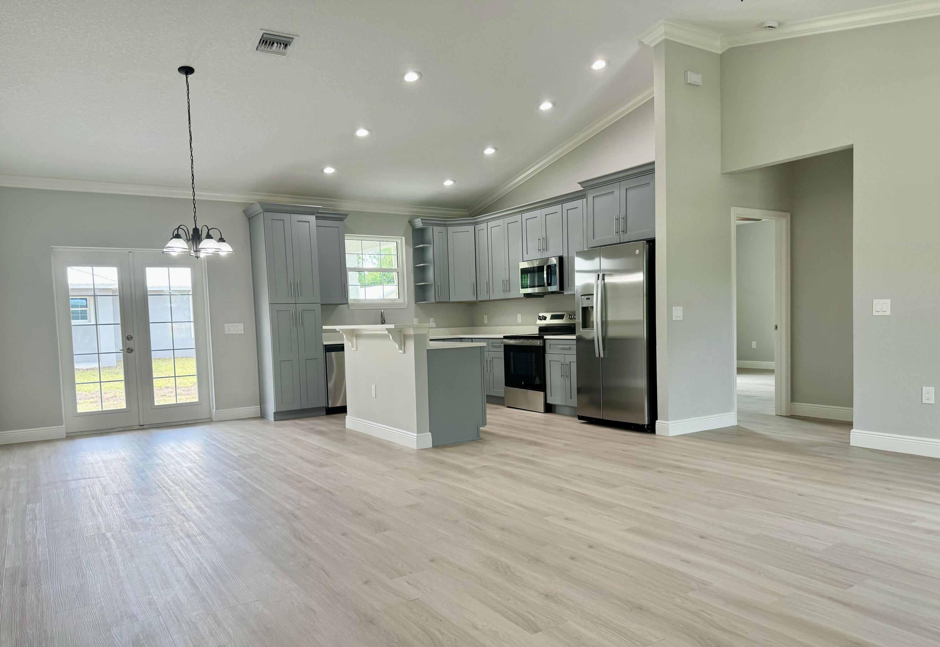 581 Southeast 36th Terrace Okeechobee, FL 34974 - Photo 2 of 19 a view of kitchen with stainless steel appliances granite countertop cabinets and wooden floor