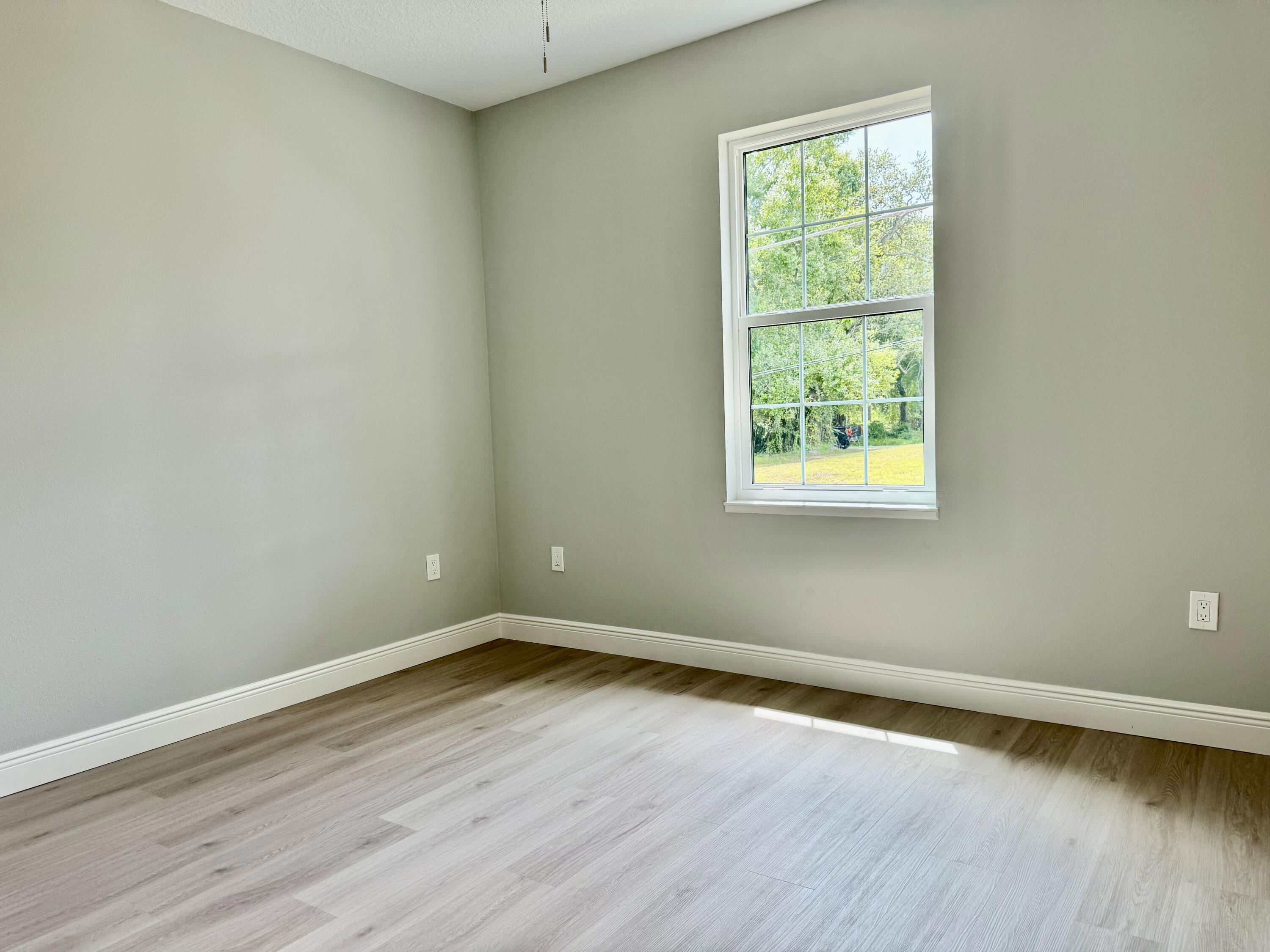 581 Southeast 36th Terrace Okeechobee, FL 34974 - Photo 10 of 19 an empty room with wooden floor and windows