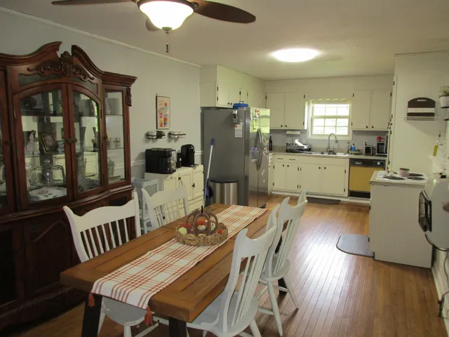 a view of a dining room with furniture and wooden floor