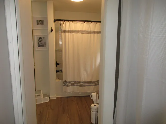 a bathroom with a glass door shower and a sink