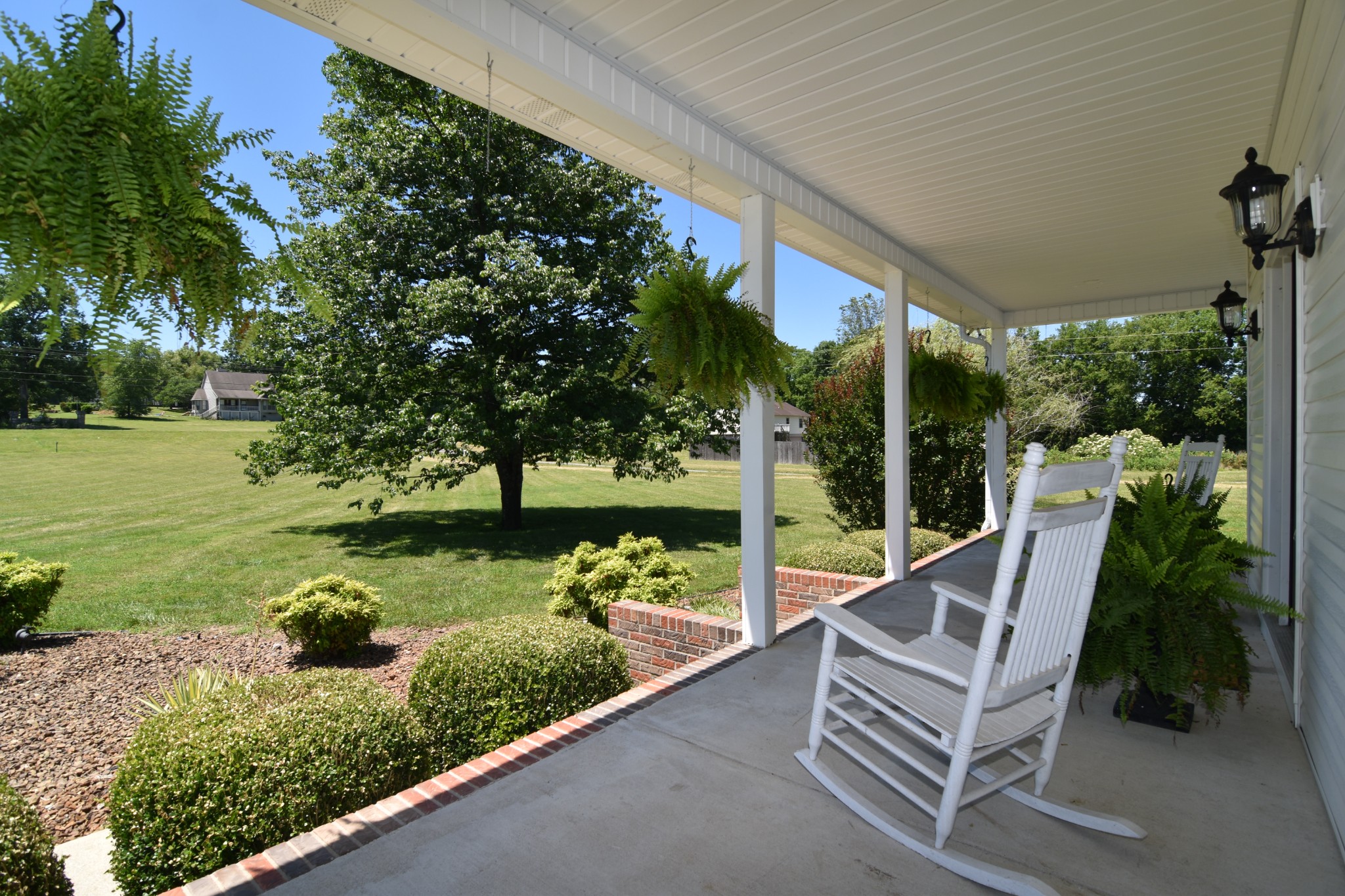 671 Chicken Road Lebanon, TN 37090 - Photo 8 of 46 a view of a chair and tables in the backyard with garden