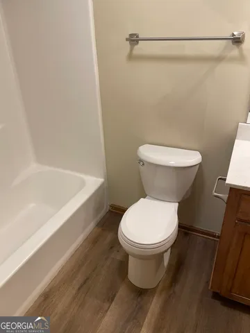 a bathroom with a toilet and a bathtub