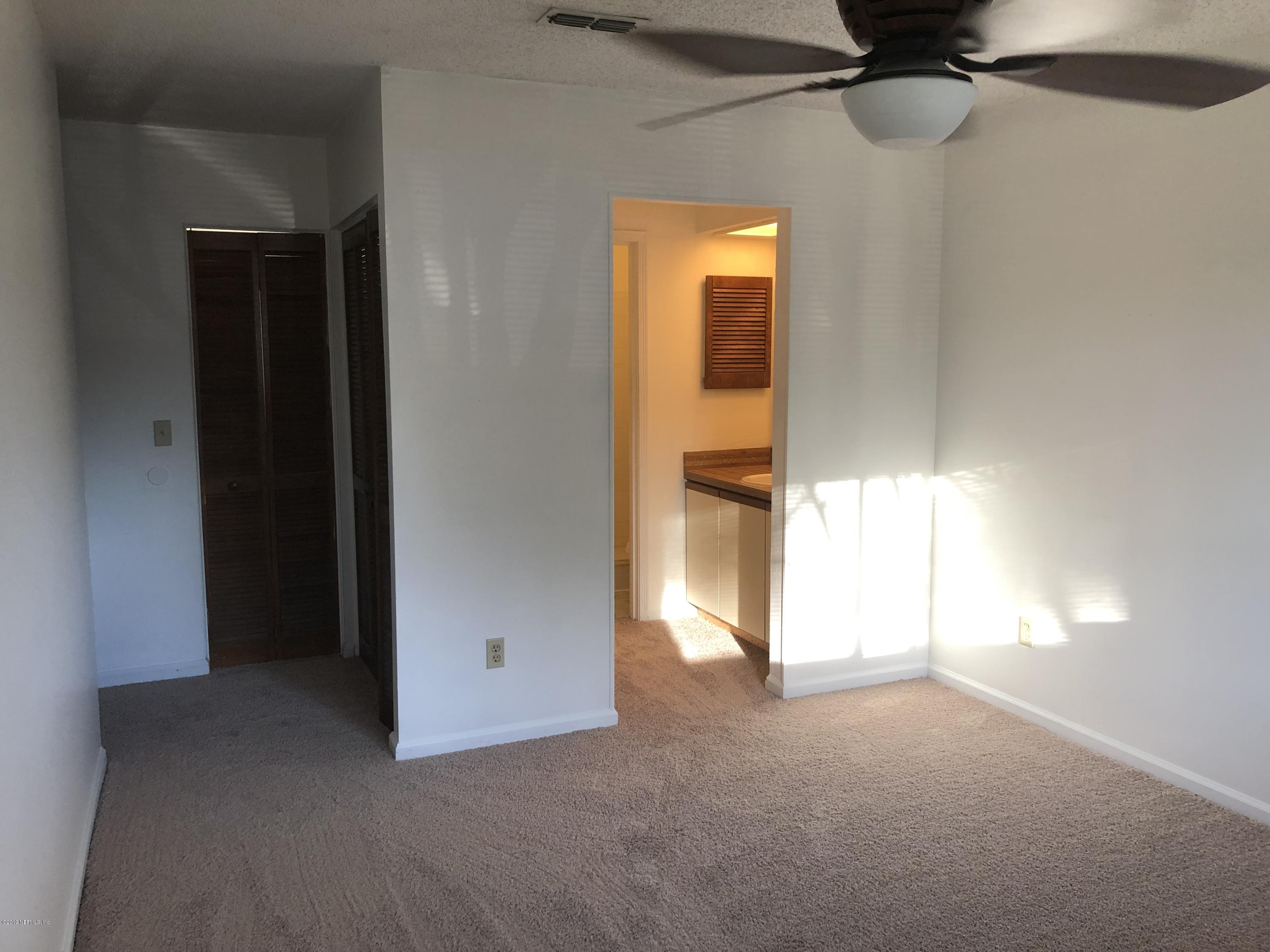 3801 Crown Point Road, Unit 3023 Jacksonville, FL 32257 - Photo 12 of 18 a view of a room with a closet and a chandelier fan