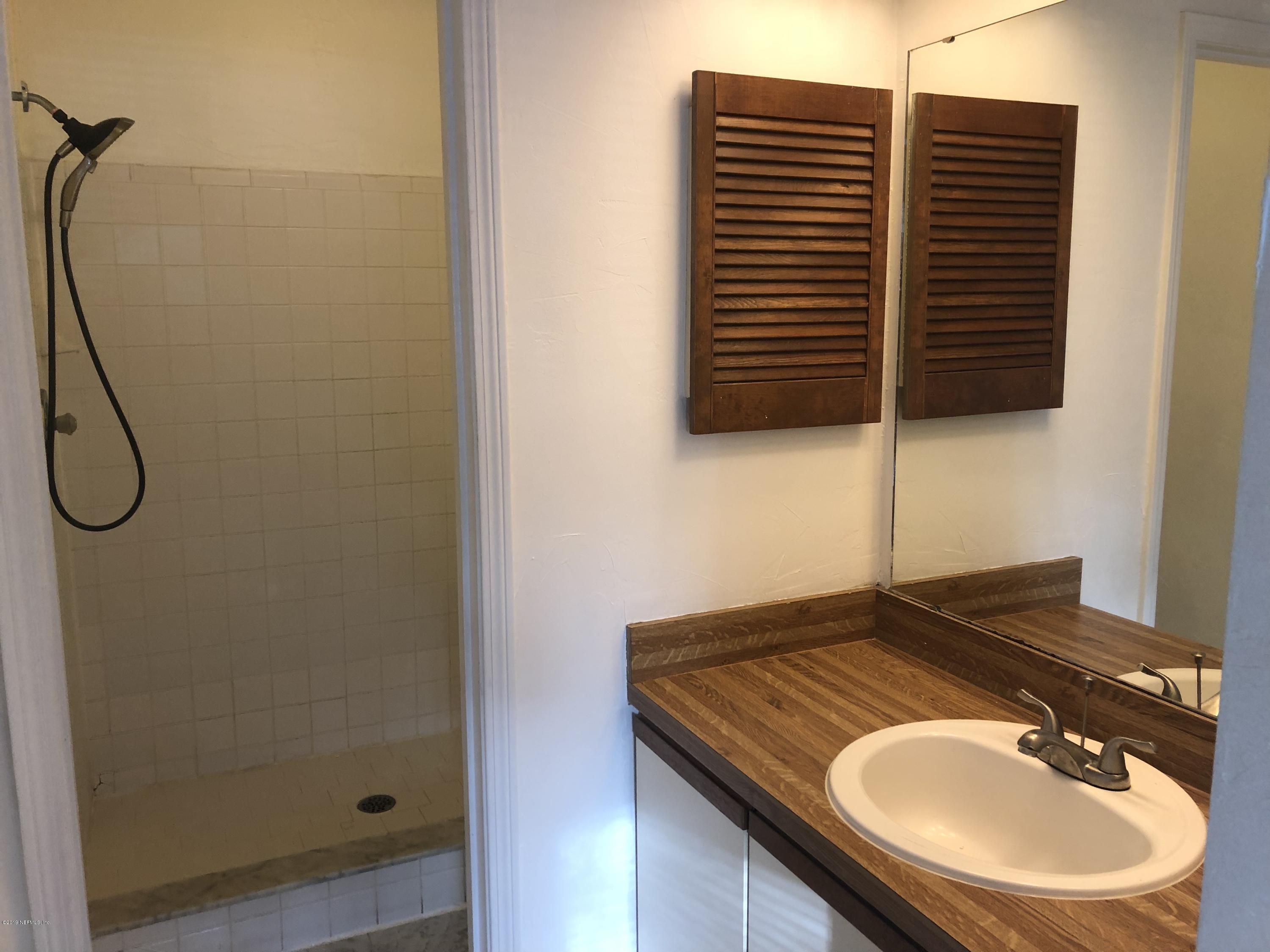 3801 Crown Point Road, Unit 3023 Jacksonville, FL 32257 - Photo 13 of 18 a bathroom with a shower sink and a mirror