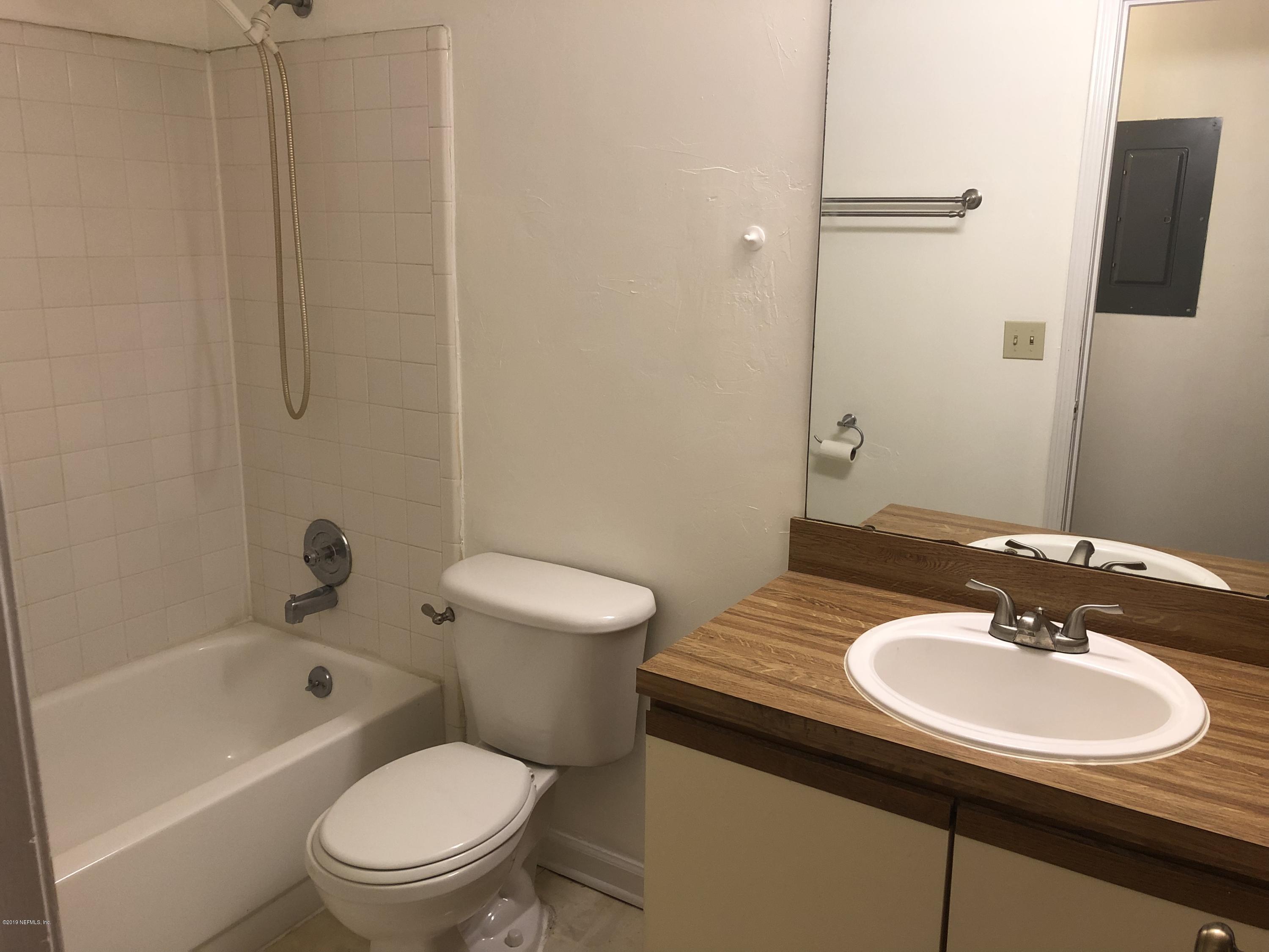 3801 Crown Point Road, Unit 3023 Jacksonville, FL 32257 - Photo 18 of 18 a bathroom with a sink toilet a shower and a mirror