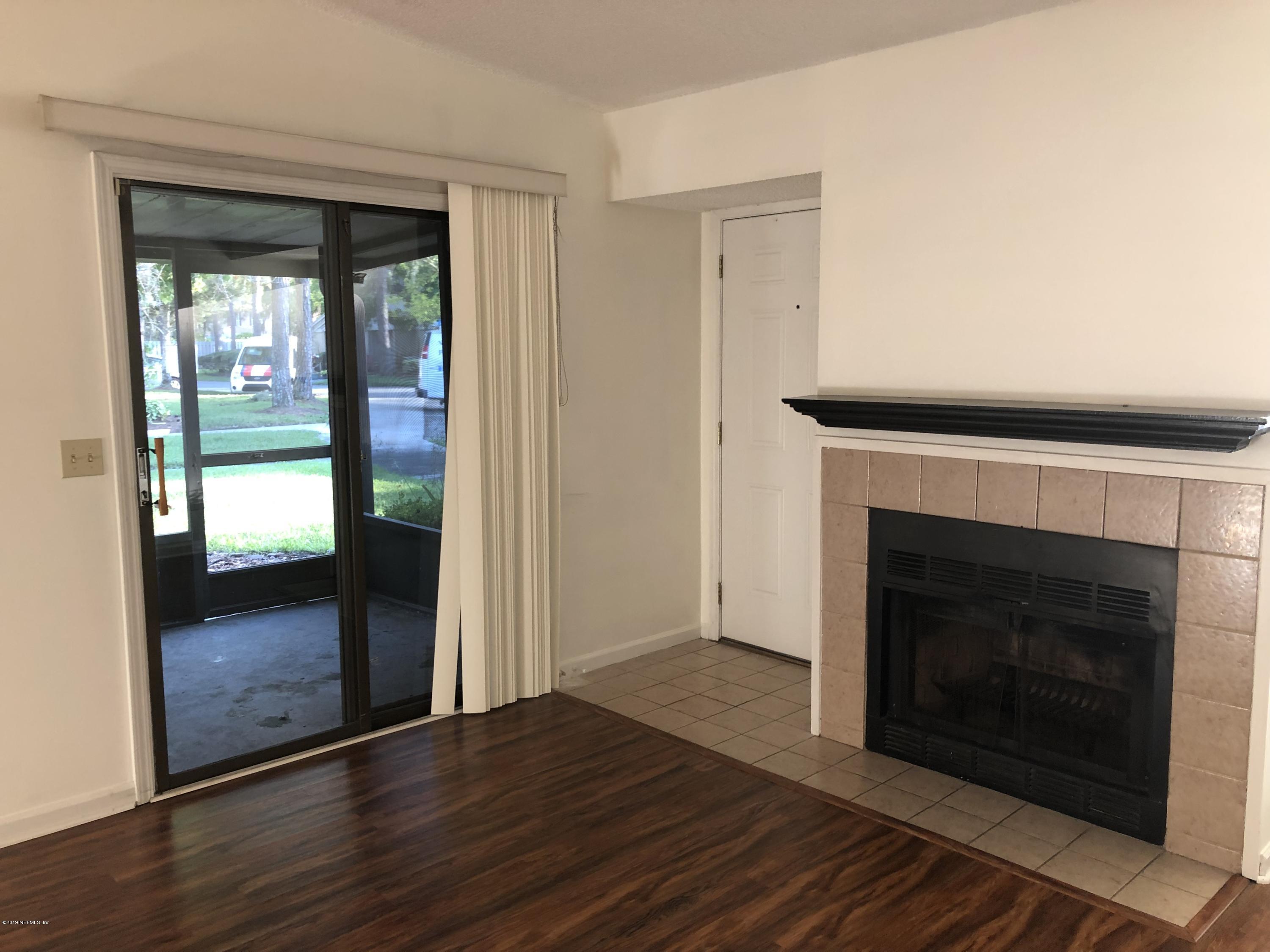 3801 Crown Point Road, Unit 3023 Jacksonville, FL 32257 - Photo 3 of 18 a living room with a fireplace